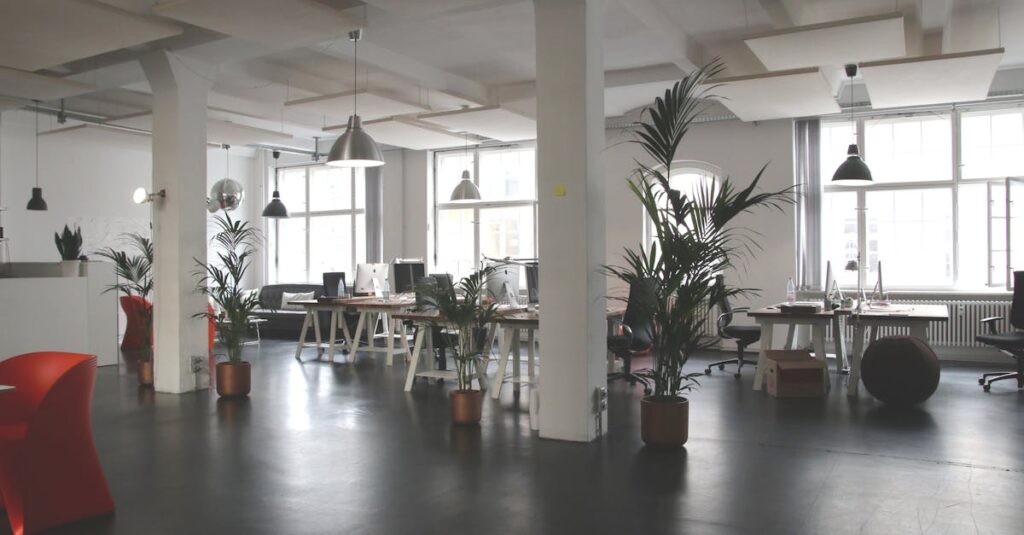 Spacious modern office interior with desks, plants, and natural lighting in Berlin.